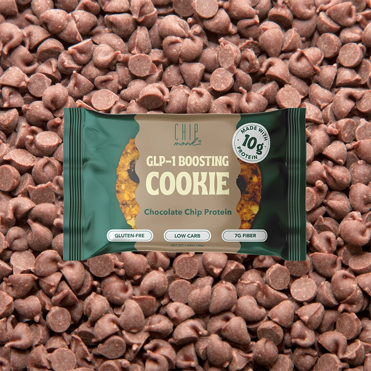 Chocolate chip protein cookie package with chocolate chips in the background