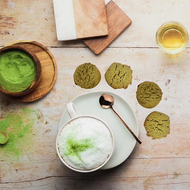 Matcha green tea latte with matcha cookies on a wooden table