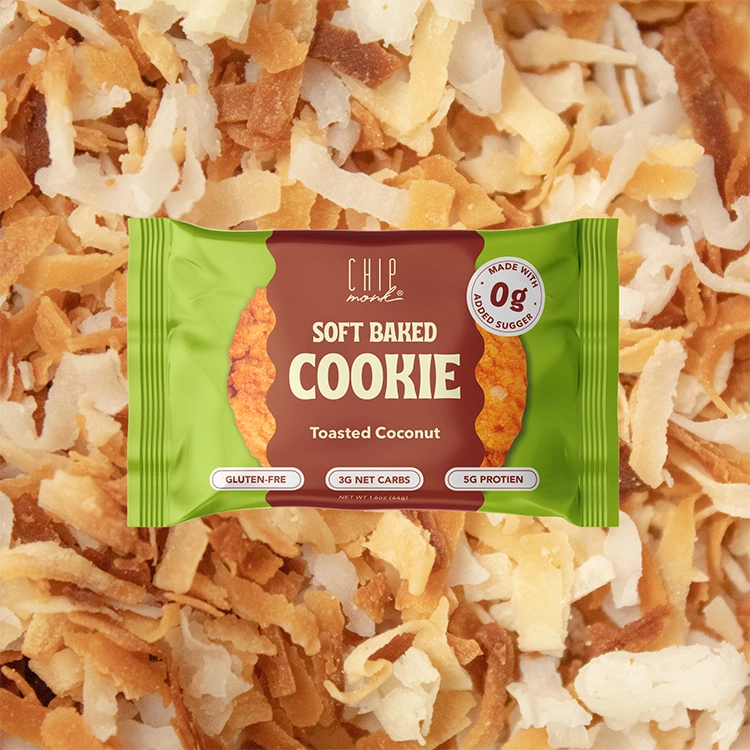 Package of soft baked cookie with toasted coconut flavor on a background of coconut flakes.