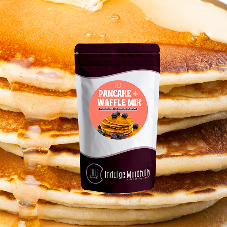 Pancake and waffle mix package with a stack of pancakes in the background
