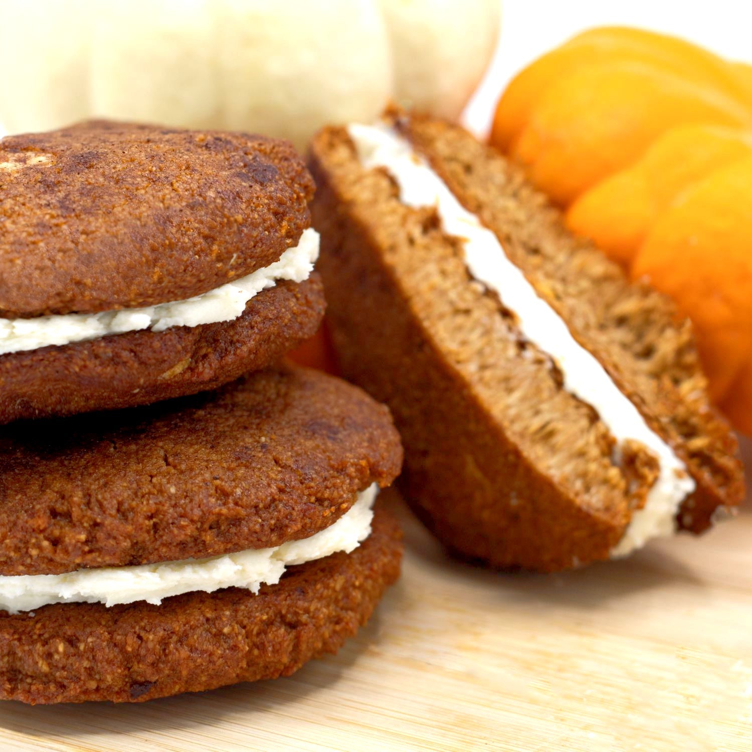 Pumpkin Spice keto cookie sandwiches stacked with pumpkins