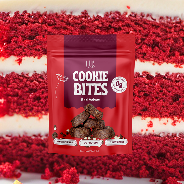 Red velvet cookie bites packaging with red velvet cake in the background