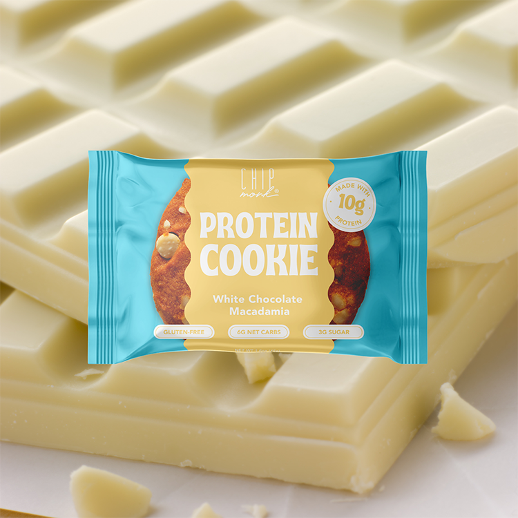 Protein cookie package with white chocolate macadamia flavor on a white chocolate background
